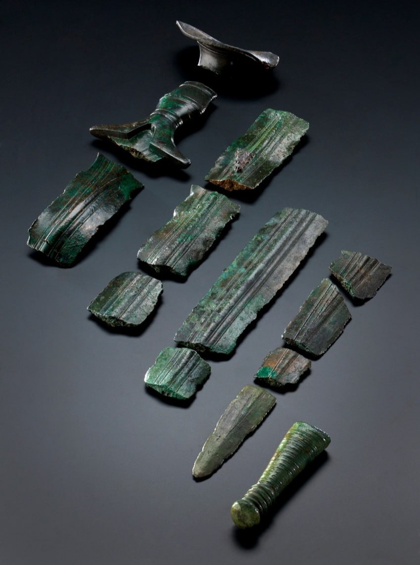 Intentionally “killed” bronze sword, Germany, 9th century BCA Mörigen-type sword with a solid metal hilt inlaid with diamond-shaped iron decoration. Dimensions: width 8.4 cm, lengt
